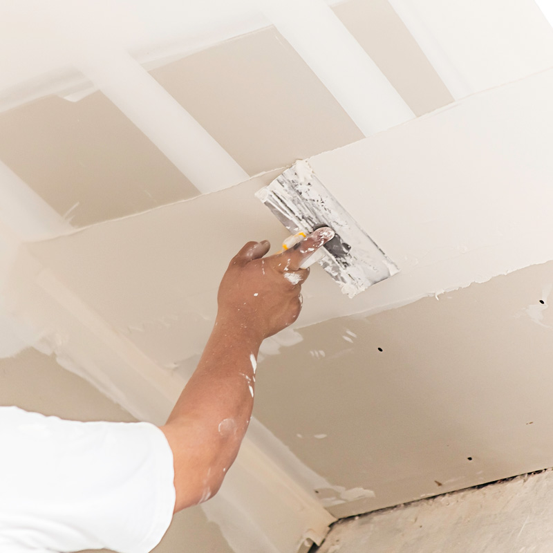 someone repairing drywall